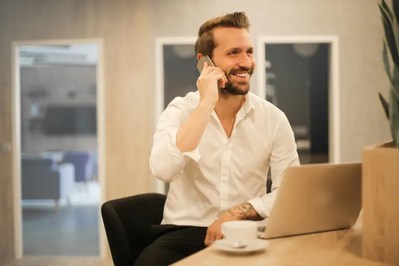 Man speaking on the phone at a desk